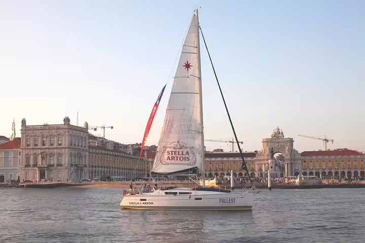 Woman enjoying a serene sunset view while sailing on the Tagus River near Lisbon.