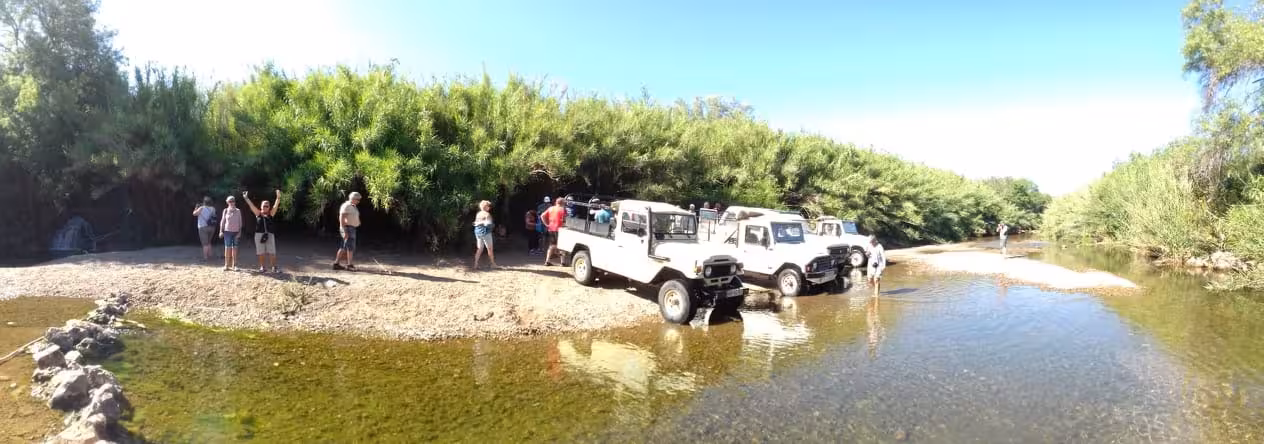 Off-road jeeps parked by a clear river on a sunset sparkling wine adventure through scenic Turkish nature