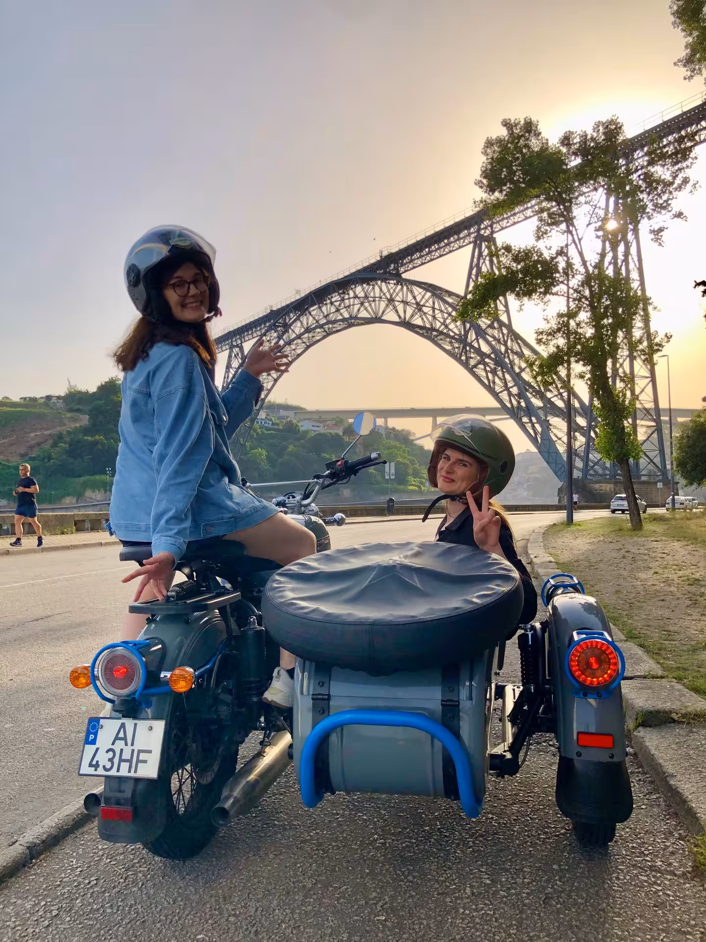 Guests on vintage sidecar by Dom Luís I Bridge at sunset, Porto tour with panoramic Douro views