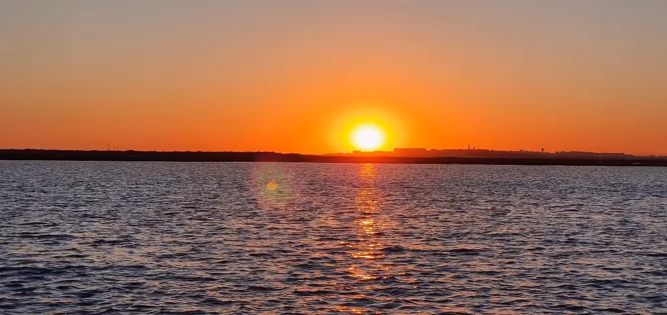 Stunning sunset over tranquil waters, perfect for a romantic evening on the Sunset Tour Privado.