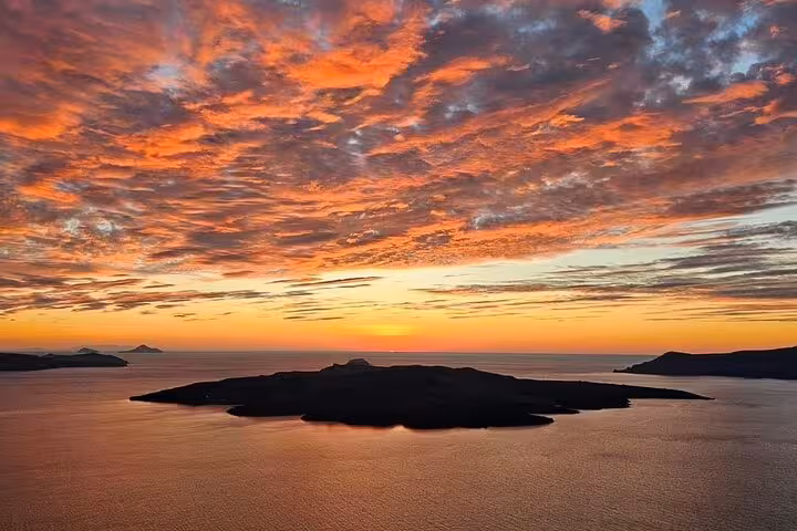 Dramatic sunset sky over island and sea, a highlight stop on a private sunset wine tour with 3 wineries and tapas