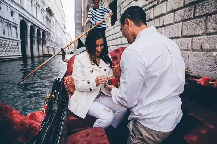 Surprise gondola proposal on Venice canal as groom presents ring, iconic engagement photoshoot with gondolier