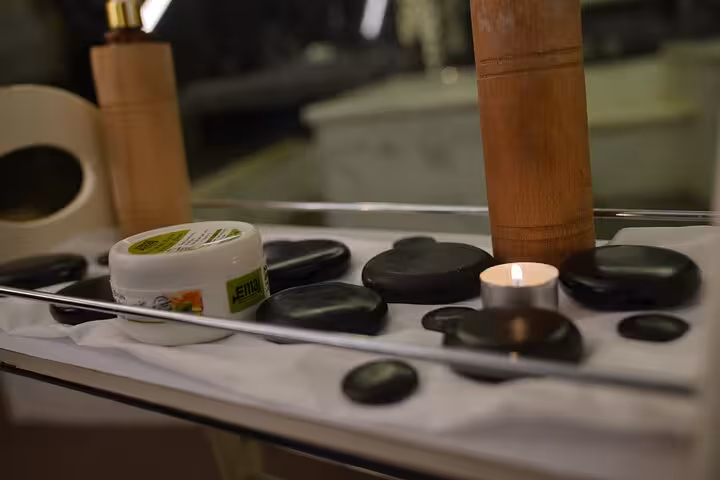 Hot stone massage setup with candle and oils for a relaxing Swedish massage experience in Sharm El Sheikh