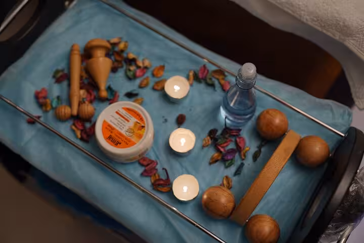 Swedish massage setup with candles, oils, and wooden tools for a relaxing spa session in Sharm El Sheikh