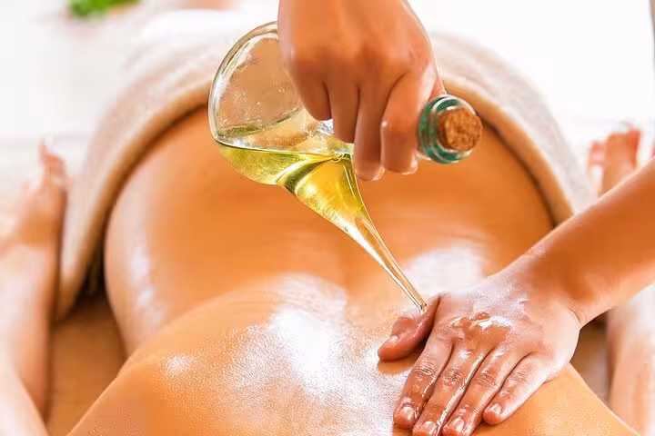 Swedish massage in Sharm El Sheikh spa with warm oil poured on back for deep relaxation and stress relief