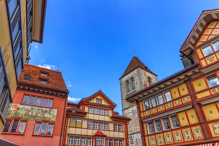 Charming Swiss architecture with colorful facades in a historic town under a clear blue sky.