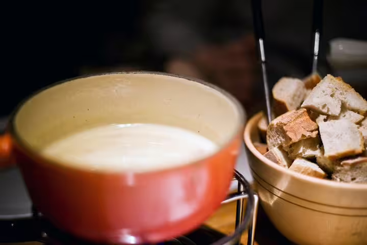 Indulge in Swiss cheese fondue with fresh bread during the Zurich Engelberg tour for a savory culinary experience.