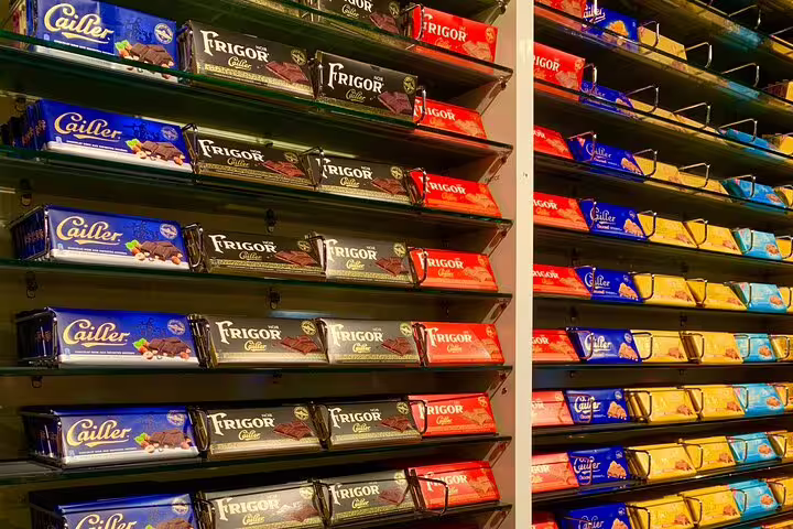 Shelves displaying a variety of Swiss chocolate bars during a Gruyères tour with chocolate tasting experience.