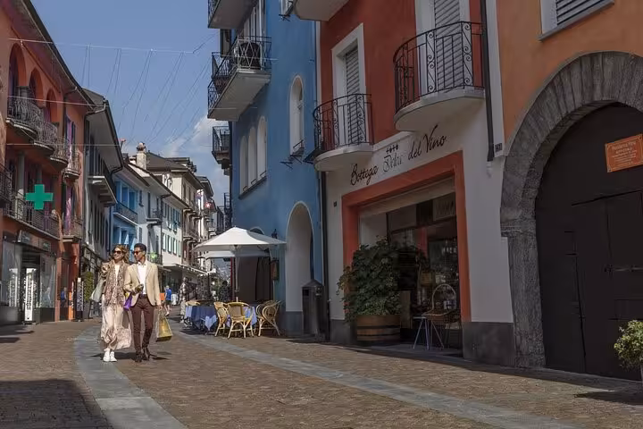 Charming Swiss street with colorful buildings and outdoor cafe in a picturesque town setting.