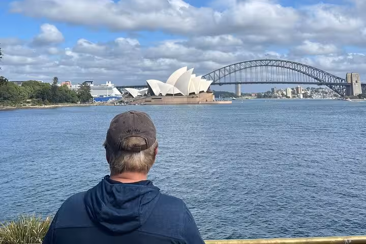 Traveler admiring Sydney Opera House and Harbour Bridge view on exclusive Sydney Private Tour sightseeing trip.