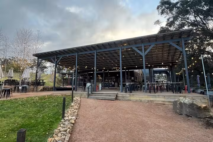 Charming Southern Highlands winery with rustic outdoor seating, perfect for a Sydney wine tasting tour experience.