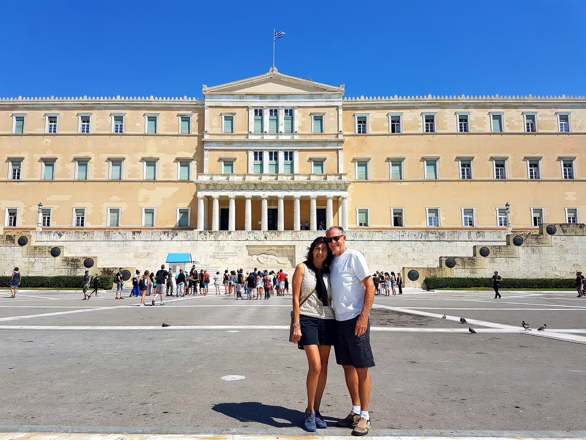 Visitors at Syntagma Square with the Hellenic Parliament in Athens, photo stop on a private city tour