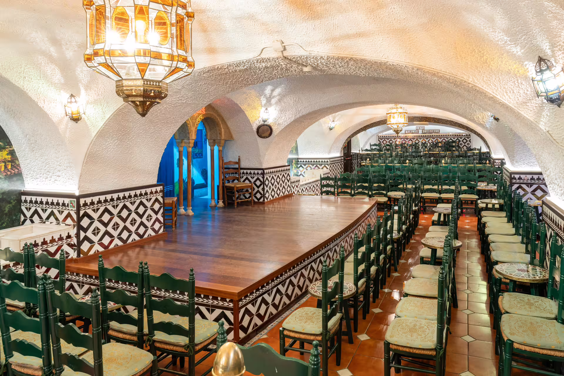 Elegant interior of Tablao Cordobes in Barcelona, featuring a traditional stage and seating for an authentic Flamenco show.
