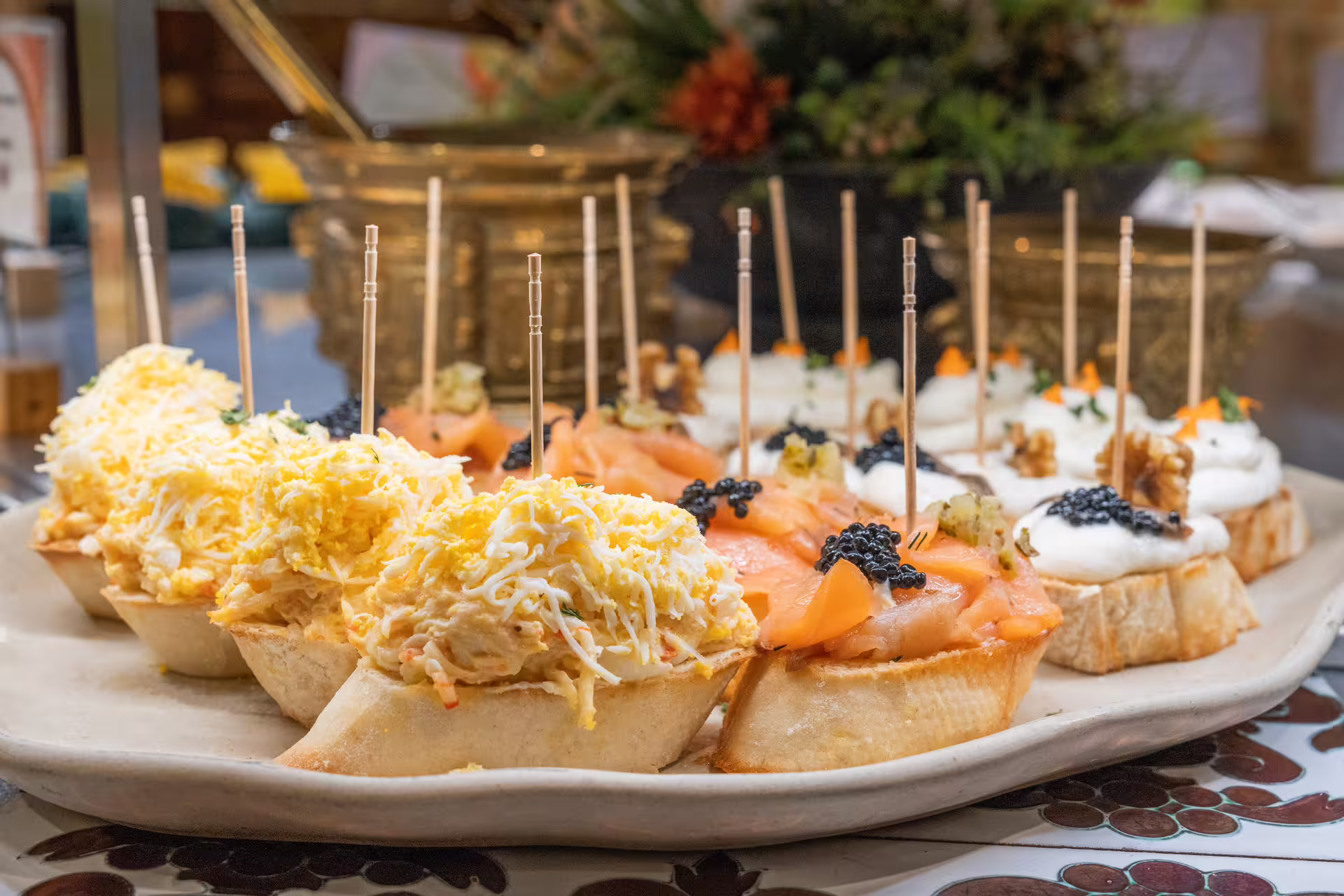 Assorted tapas including smoked salmon and creamy toppings served at Tablao Cordobes in La Rambla, Barcelona.