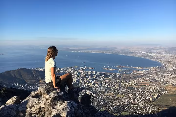 Woman enjoying breathtaking views from Table Mountain, a highlight of the Cape Town tour featuring Boulder Beach and Cape Point.
