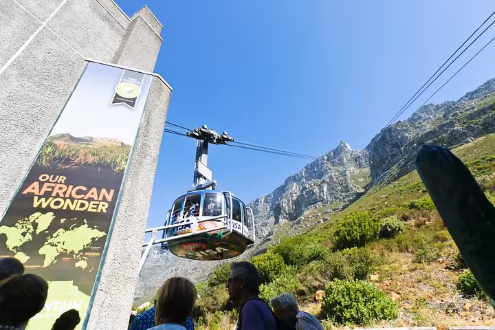 Cable car at Table Mountain station with visitors, highlighting the breathtaking views of Cape Town's iconic landmark.