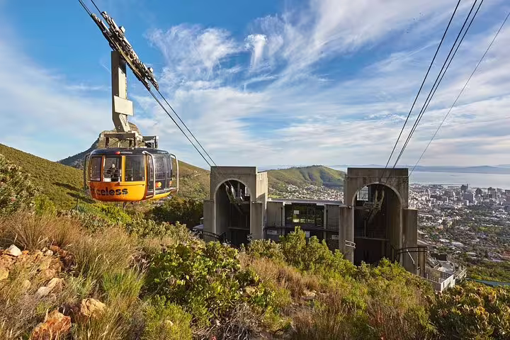 Cable car ascending Table Mountain offers panoramic views of Cape Town, a must-see on any shared group tour.