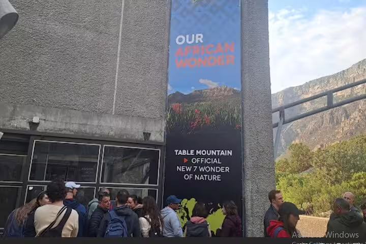 Tourists gather at the entrance of Table Mountain, marked as an official New 7 Wonder of Nature.