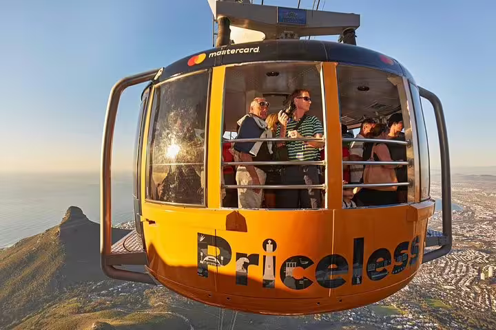 Tourists enjoying panoramic views from the Table Mountain cable car, highlighting the scenic beauty of Cape Town.