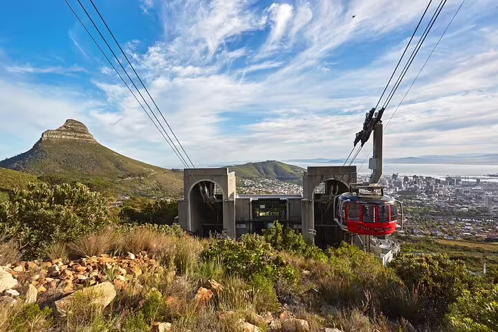 Table Mountain cableway station with panoramic views of Cape Town and Lions Head under a clear blue sky.