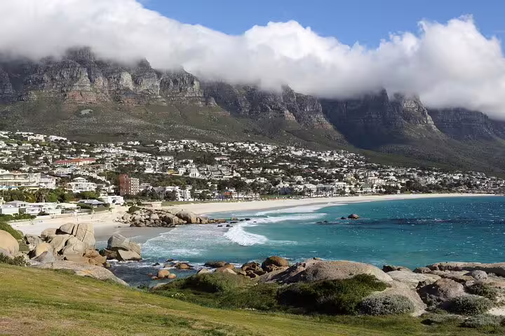 Scenic view of Table Mountain with clouds over Camps Bay beach, perfect for a Cape Town tour adventure.