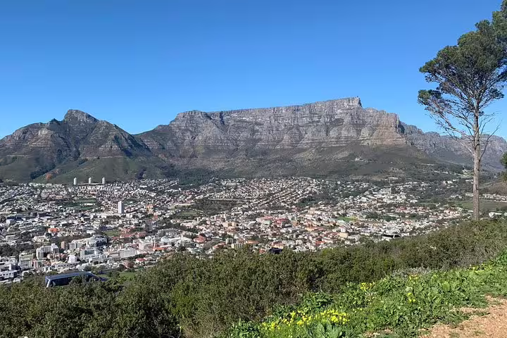 Stunning view of Table Mountain and Cape Town cityscape under clear blue skies, perfect for a South African adventure.
