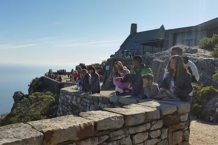 Visitors enjoying the panoramic views from the top of Table Mountain on a sunny day.