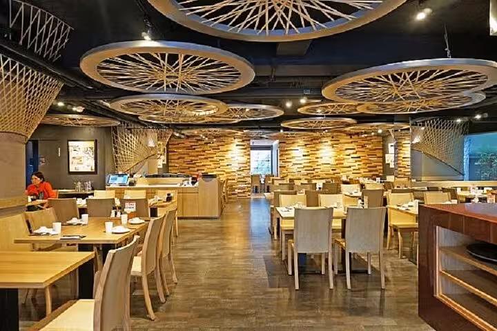 Modern and stylish interior of Taipei Hungzhou Xiaolongbao, featuring unique ceiling designs and warm wooden decor.