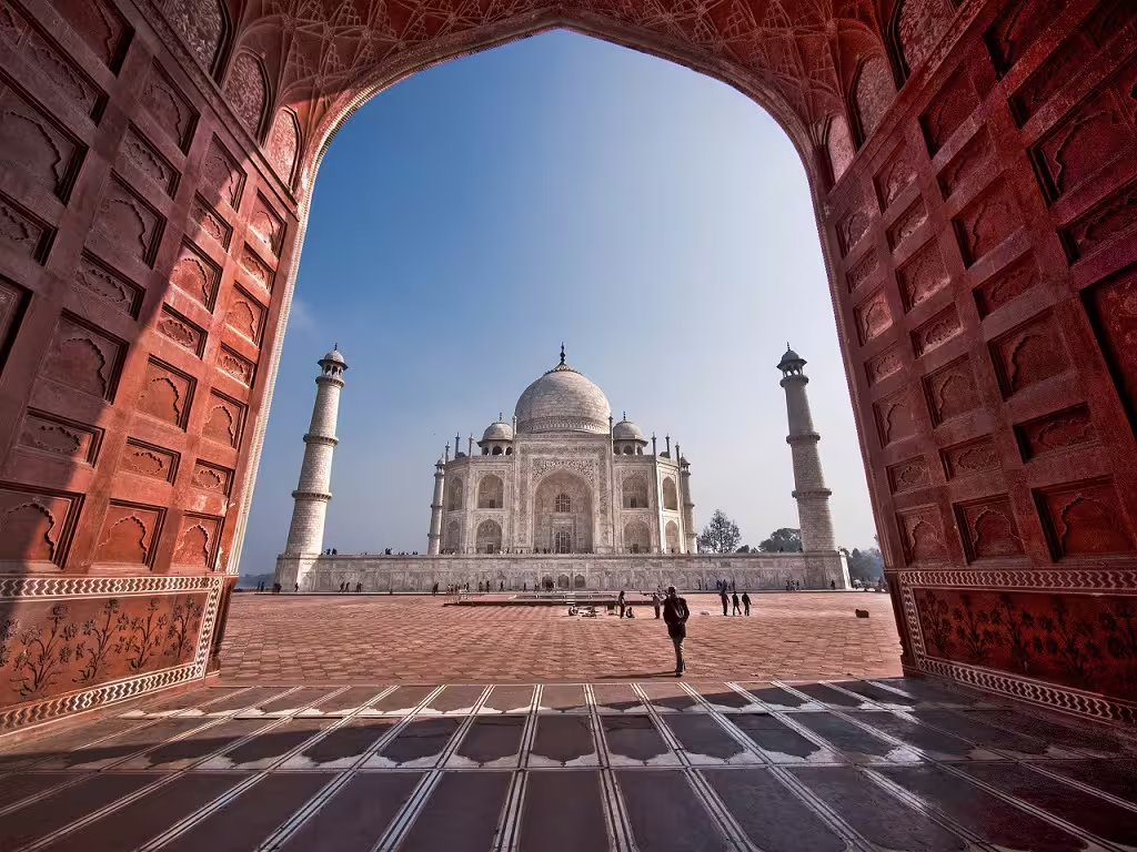 Marvel at the iconic Taj Mahal through the grand entrance, a highlight of our Classical North India journey.