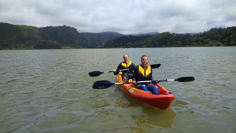 Two paddlers in a tandem kayak on a calm lake, ideal for a half-day canoeing tour without transportation