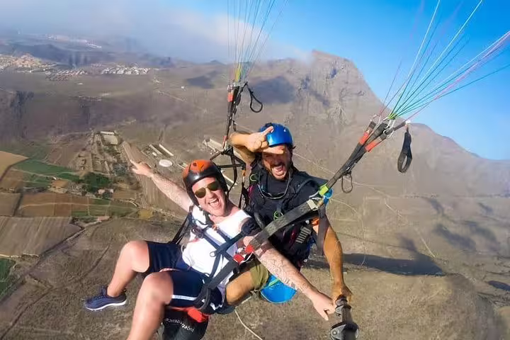 Thrilling tandem paragliding adventure over scenic landscapes, offering breathtaking views at 800 meters altitude.