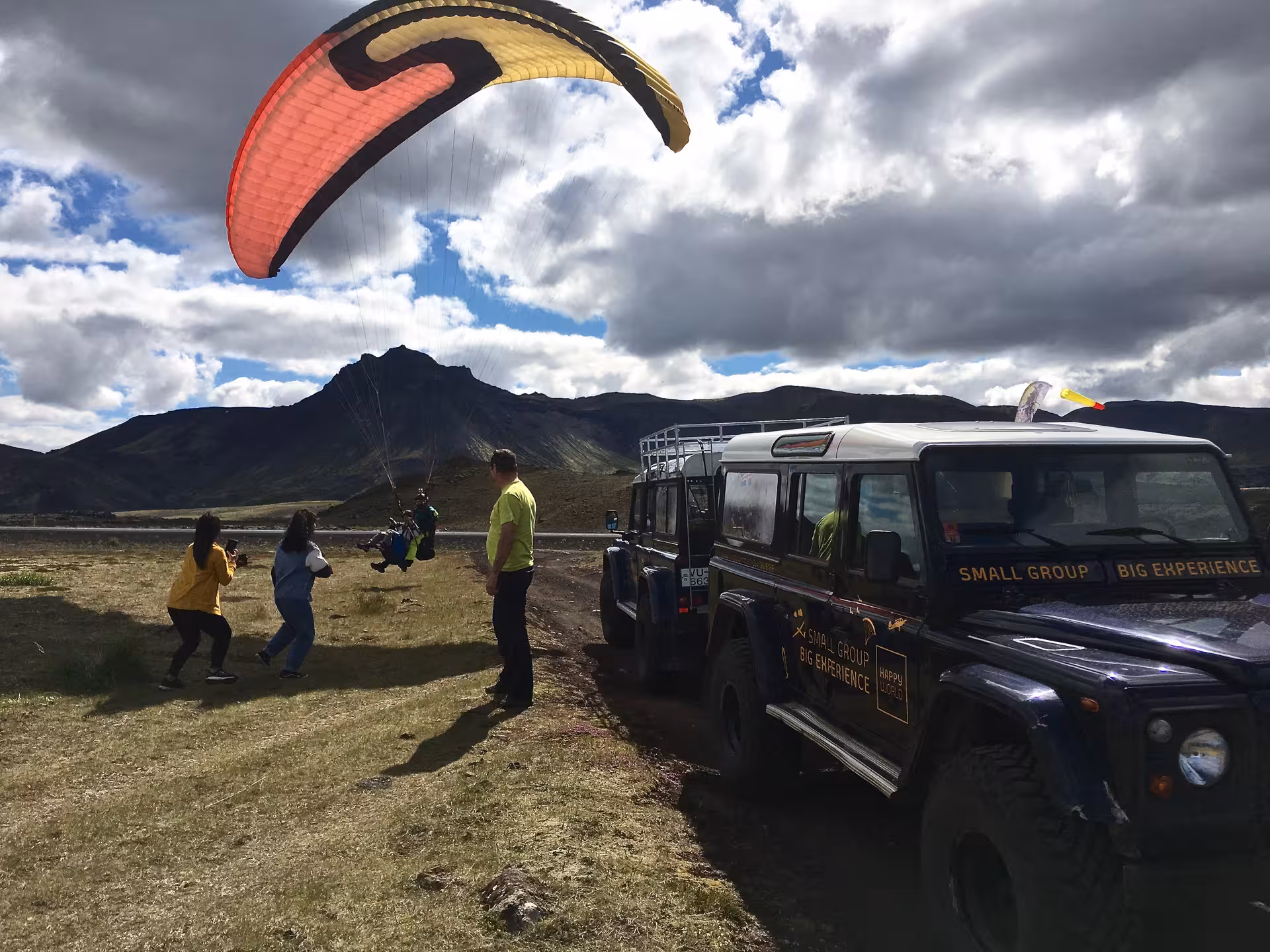 GoPro view of tandem paraglider soaring above Blue Mountains rugged lava fields, Iceland adrenaline tour