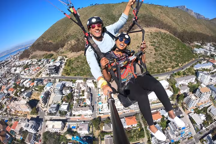 Thrilling tandem paragliding over Cape Town with scenic city and mountain views below.