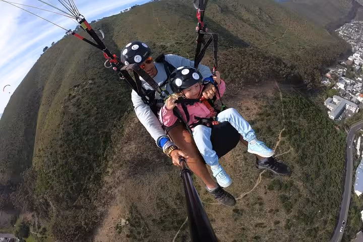 Enjoy an exhilarating tandem paragliding adventure over Cape Town's lush landscapes with stunning aerial views.