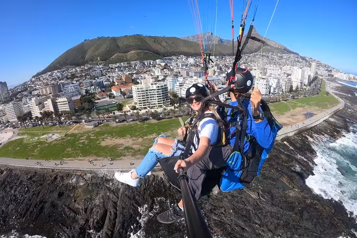 Experience thrilling tandem paragliding over Cape Town's stunning coastline with breathtaking city and mountain views.