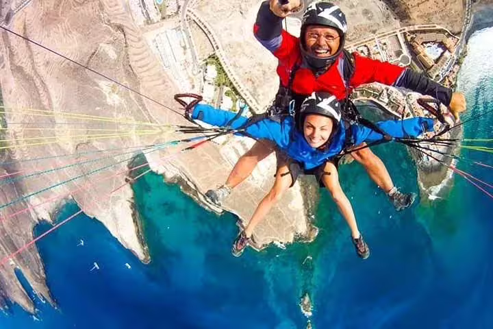 Enjoy a thrilling tandem paragliding ride over scenic coastal landscapes, capturing breathtaking aerial views at 1000 meters.