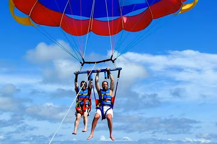 Tandem parasailing in Sharm El Sheikh above the Red Sea, safe harness ride with private hotel transfer included