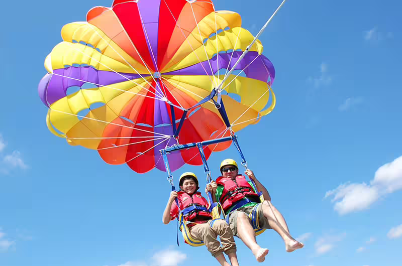 Tandem parasailing in Sharm El Sheikh over the Red Sea, colorful canopy on thrilling water sports excursion