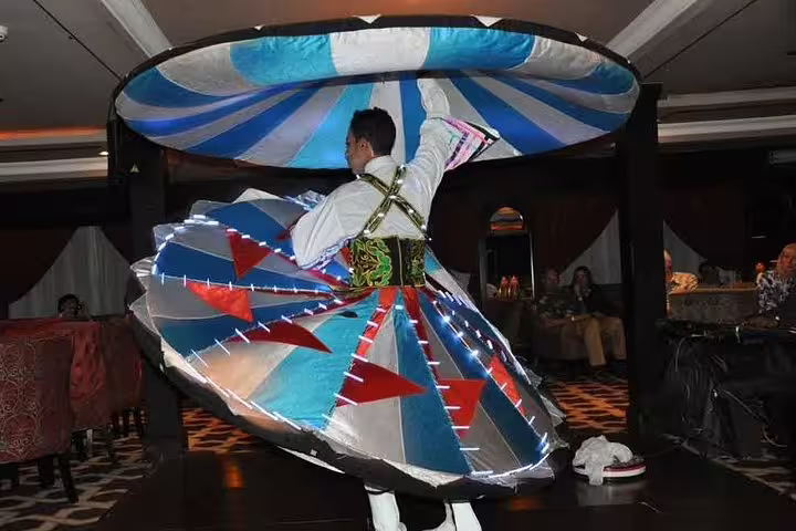Tannura whirling dervish dancer spinning in LED skirt during Nile Maxim dinner cruise show in Cairo