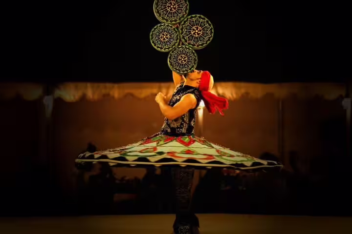 Tanoura dancer spinning during Bedouin dinner show on Jeep safari adventure tour in Marsa Alam desert