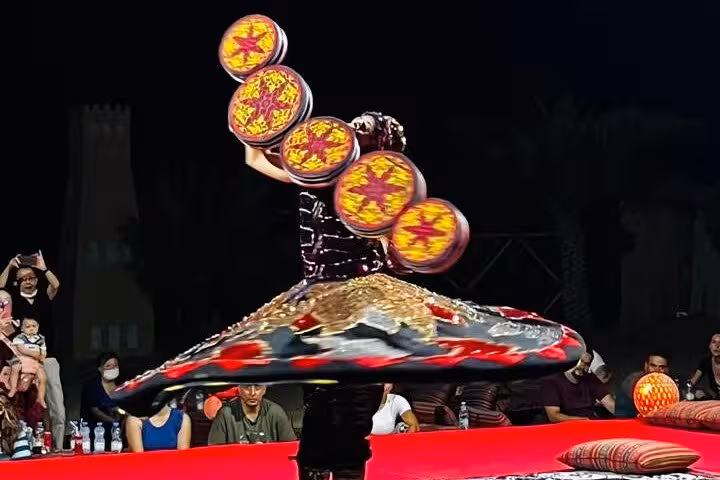 Tanoura dancer spinning at Ras Al Khaimah desert camp show during desert safari dinner experience