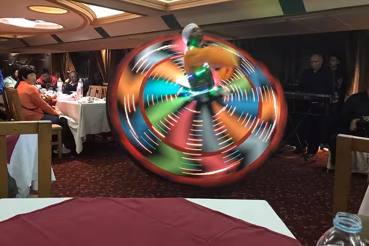 Tanoura dancer spinning LED skirt during Nile River dinner cruise with live traditional music in Cairo