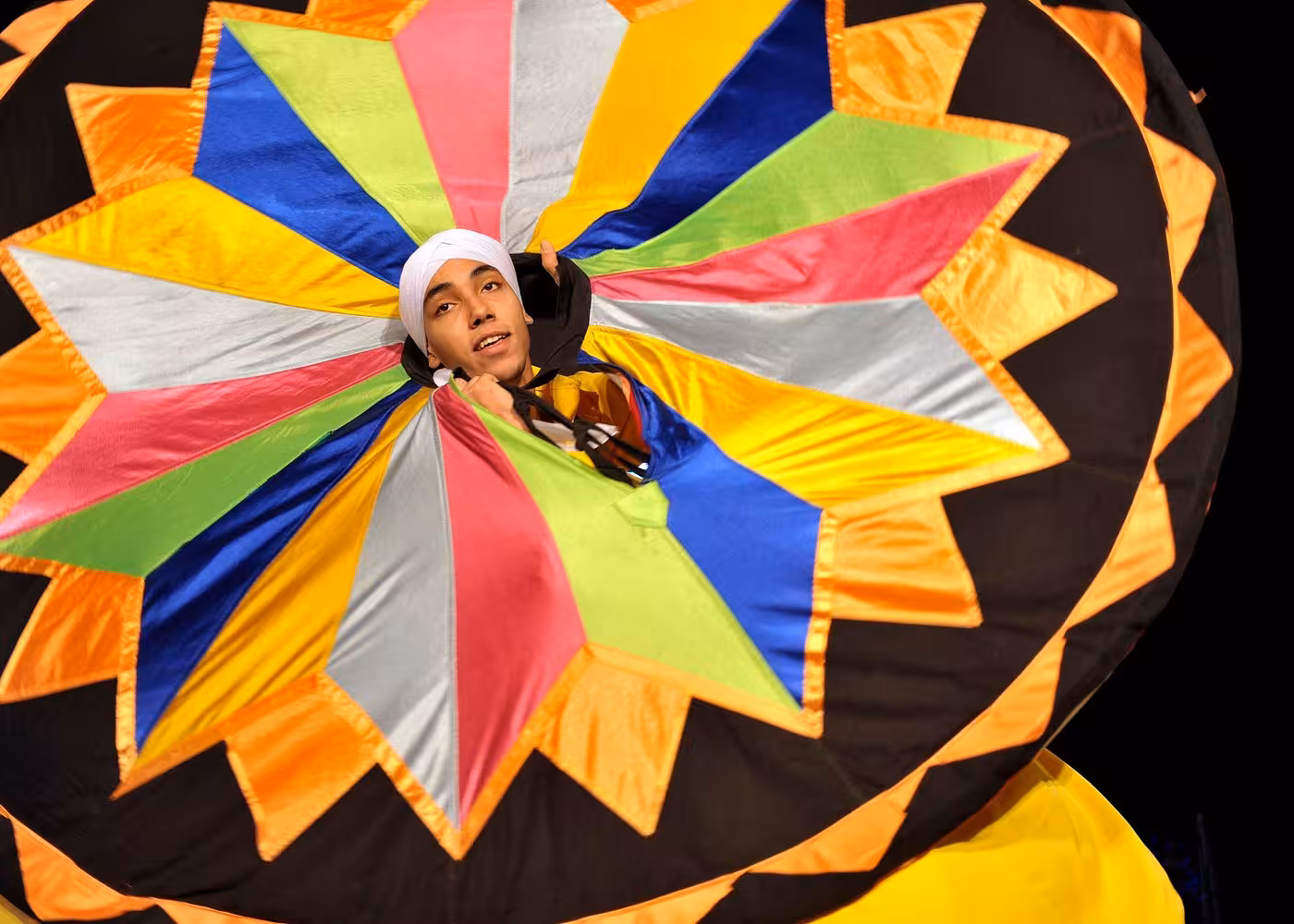 Tanoura dancer in colorful skirt performing live on a VIP private Nile River dinner cruise in Cairo at night