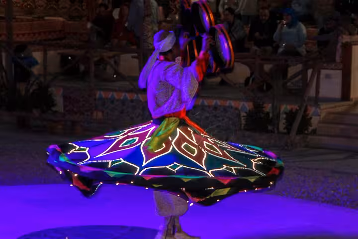 Tanoura dancer in LED skirt during Viva Safari dinner and show, part of quad and spider car desert tour