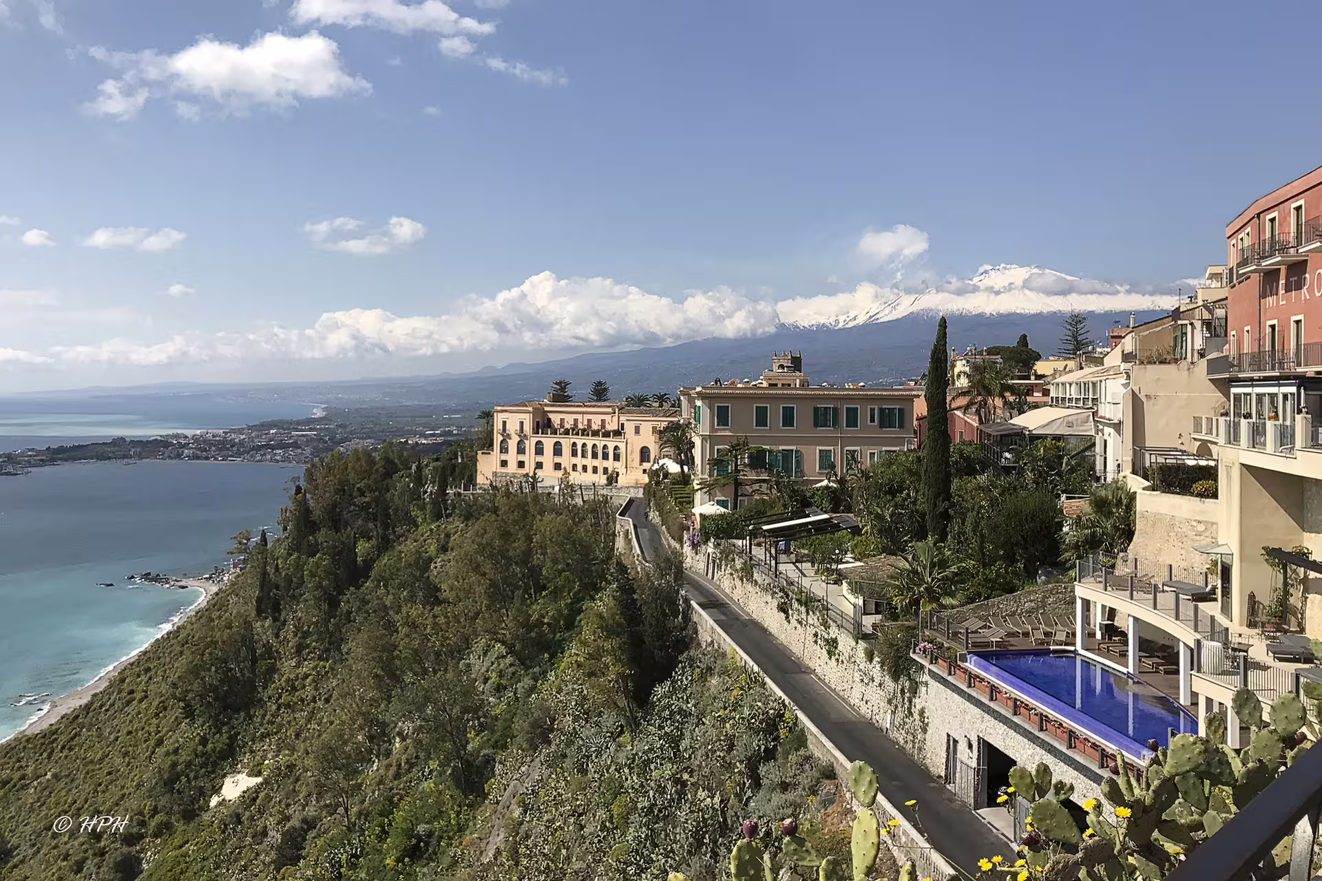Scenic Taormina hillside with luxury villas, coastal views and snow-capped Mount Etna on a private tour from Palermo