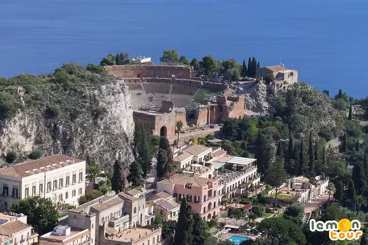 Aerial view of Taormina's ancient Greek theater overlooking the Mediterranean on the Etna and Taormina Tour.