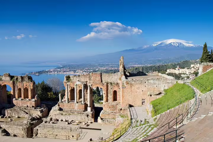 Ancient Greek Theatre of Taormina overlooking the Ionian Sea and snow-capped Mount Etna on a private sightseeing tour