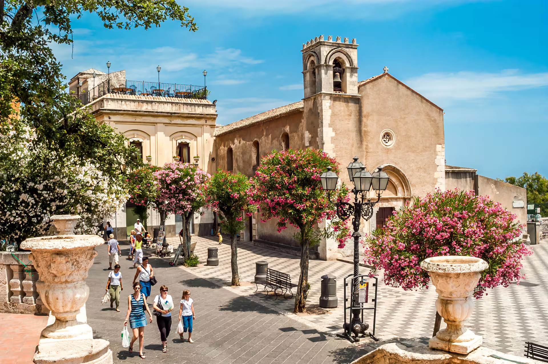 Taormina historic square with church and blooming oleanders on Etna day trip from Siracusa