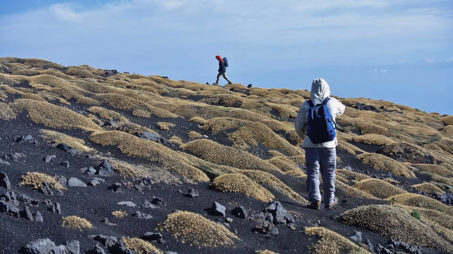 Trekkers navigate the rugged terrain of Mount Etna's volcanic slopes in Taormina, perfect for an adventurous hiking tour.