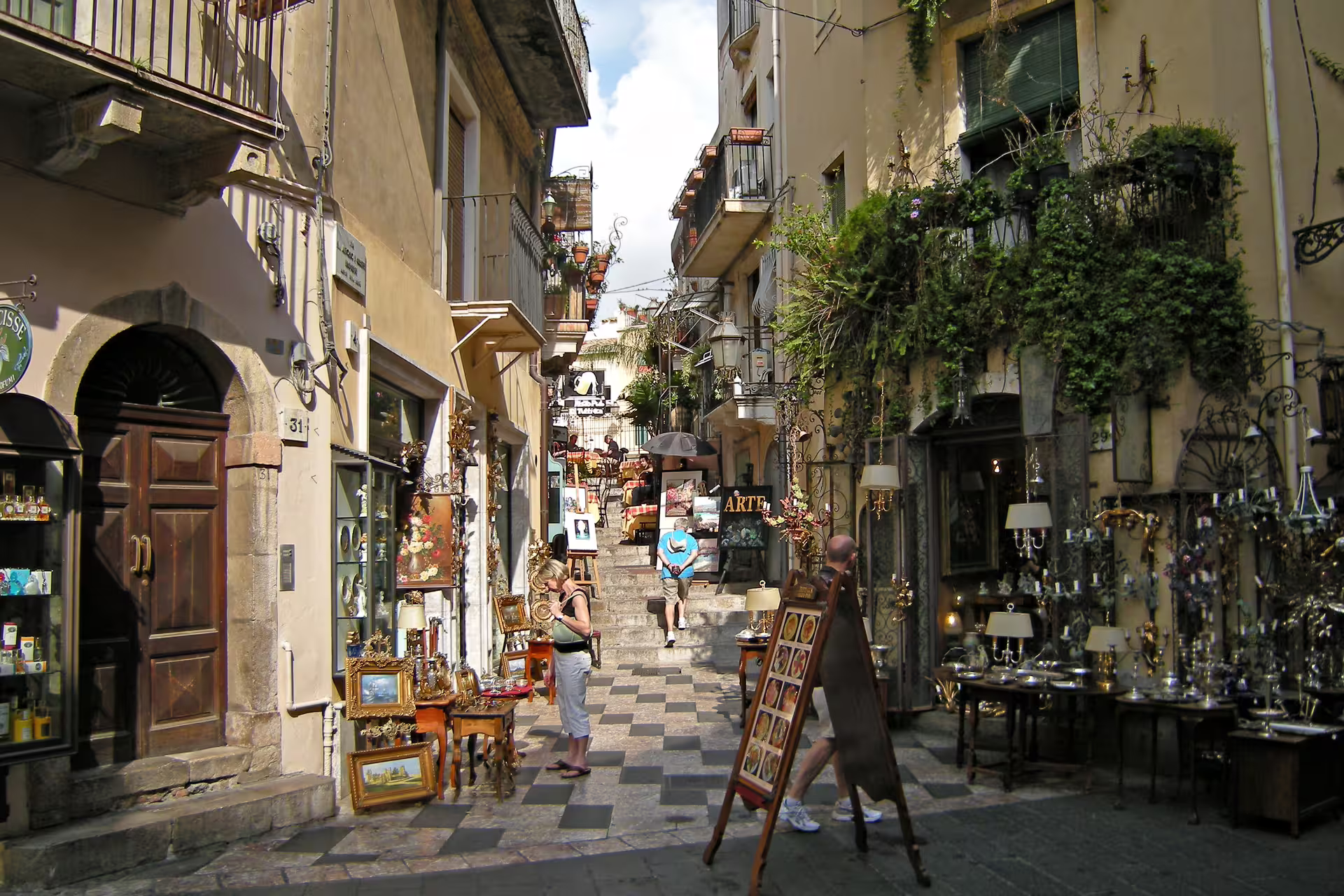 Taormina old town street with artisan shops and balconies, a highlight of the Messina Port shore excursion
